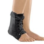 Functional ankle orthosis with lateral stabilizing reinforcements. The orthosis is made of breathable textile inelastic material, removable pellets are made of plastic.