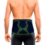 Stabilizing lumbar belt with integrated massage pad - active bandage for use in sports, work and everyday life.