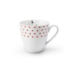 Porcelain mug decorated with red polka dots and a flying bird motif.